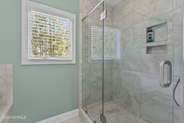 bathroom featuring a shower with door