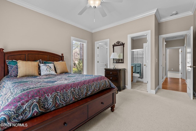 bedroom featuring crown molding, light colored carpet, ceiling fan, and ensuite bathroom