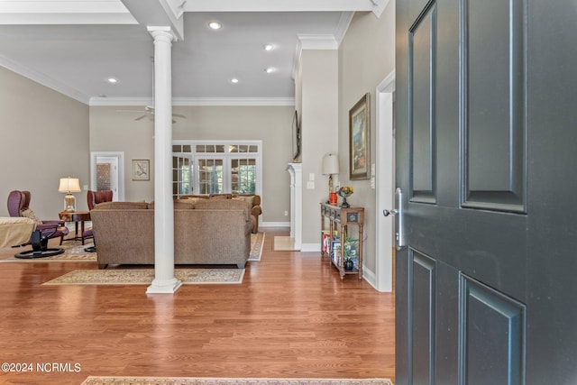 living room featuring ceiling fan, ornamental molding, wood-type flooring, and ornate columns