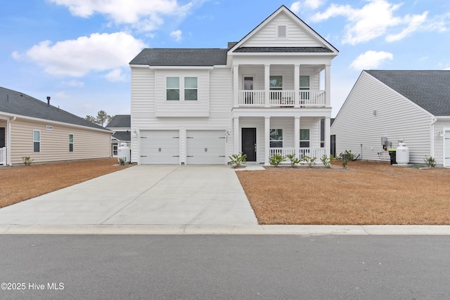 view of front of home with a garage, a balcony, and a porch