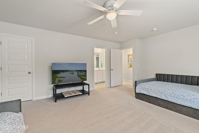 carpeted bedroom featuring ensuite bath and ceiling fan