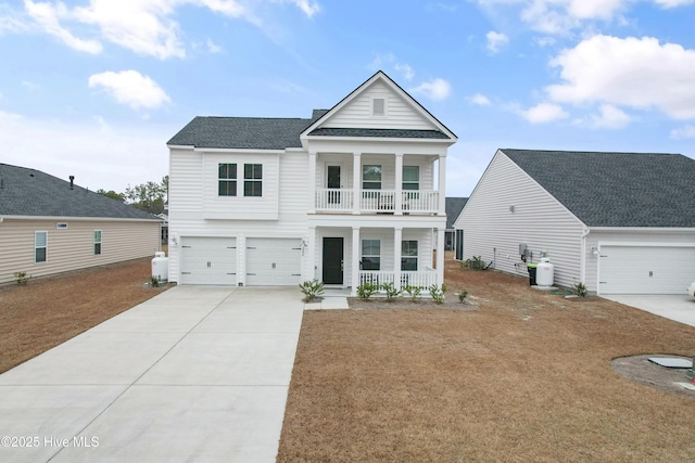 view of front of house featuring a garage, a balcony, and covered porch