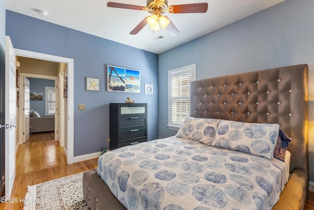 bedroom featuring hardwood / wood-style flooring and ceiling fan