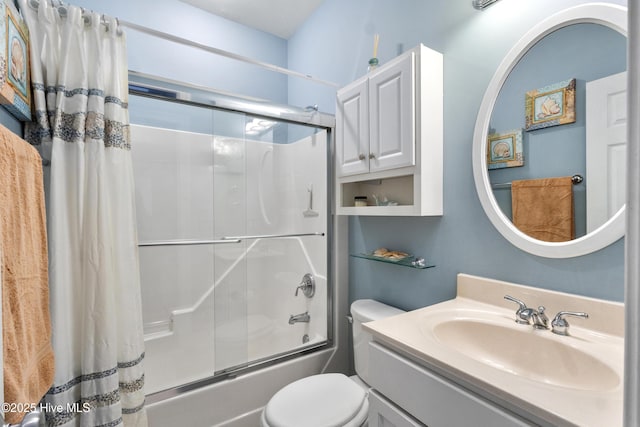 full bathroom featuring shower / tub combo with curtain, toilet, and vanity