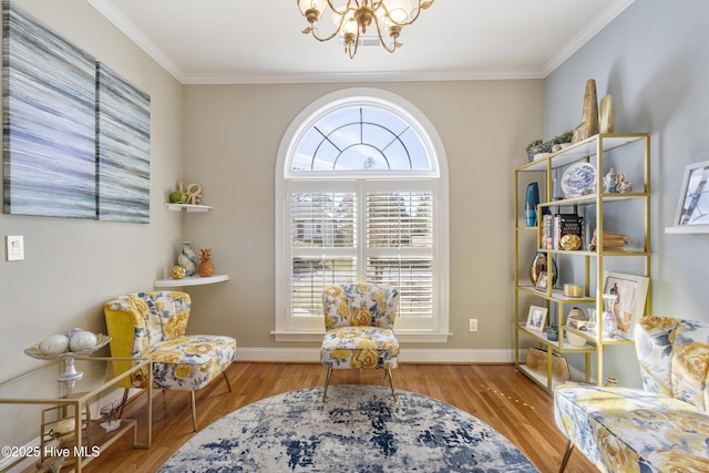 living area with light wood-type flooring, an inviting chandelier, and ornamental molding