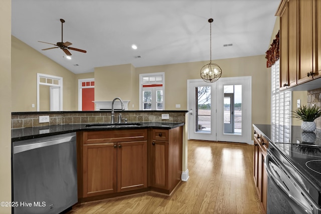 kitchen featuring brown cabinetry, a sink, light wood-style flooring, and stainless steel dishwasher