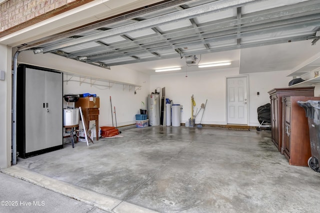 garage with water heater and a garage door opener