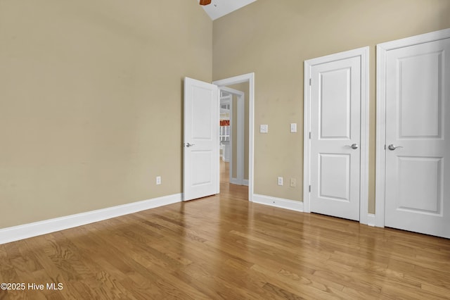 unfurnished bedroom with light wood-style flooring and baseboards