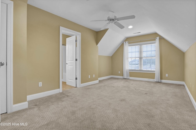 additional living space with lofted ceiling, ceiling fan, carpet flooring, visible vents, and baseboards