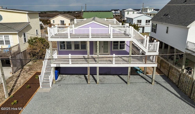 rear view of property featuring a residential view and stairs