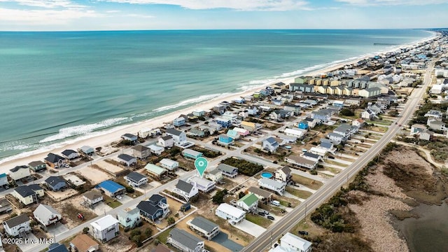 birds eye view of property with a water view and a view of the beach