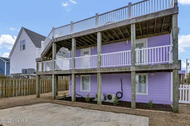 back of house featuring a patio, fence, and a wooden deck