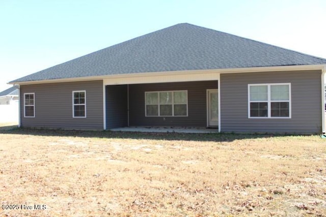 rear view of property with a lawn