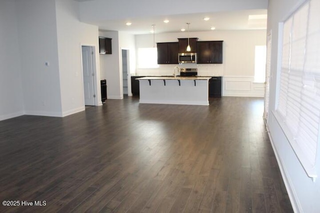 unfurnished living room with dark hardwood / wood-style floors and sink