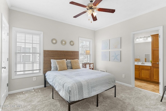 bedroom with sink, ceiling fan, ensuite bathroom, ornamental molding, and light carpet