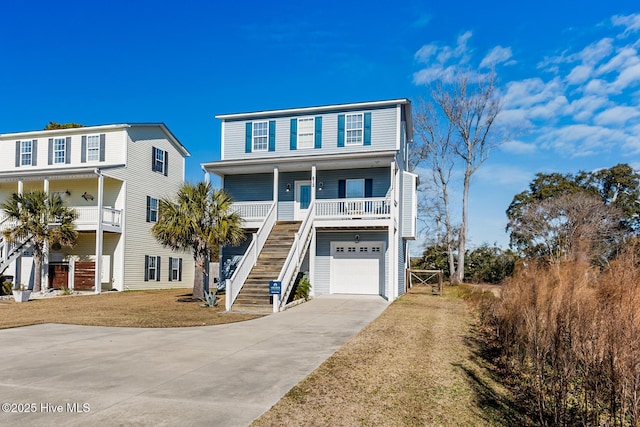 raised beach house with a porch, a garage, and a front yard