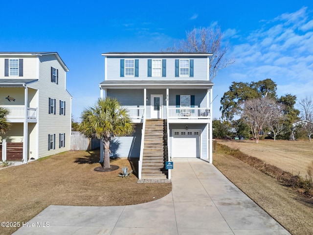 coastal inspired home with a garage, covered porch, and a front lawn