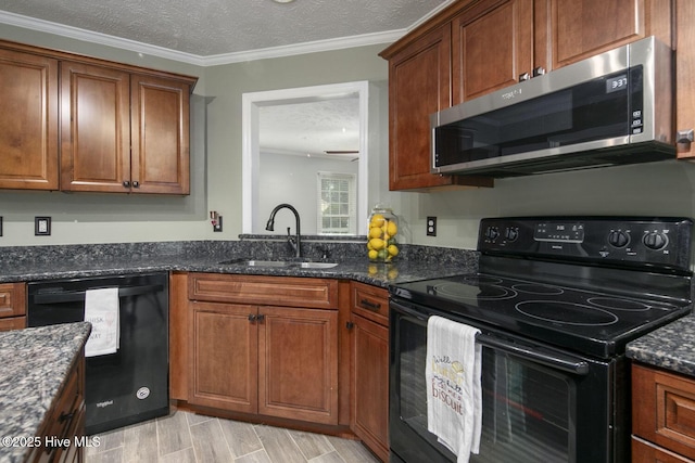 kitchen featuring sink, dark stone countertops, black appliances, a textured ceiling, and light hardwood / wood-style flooring