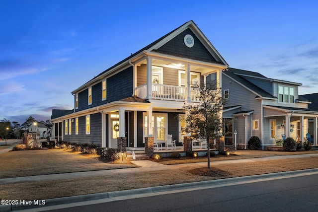 view of front of house featuring a balcony and covered porch