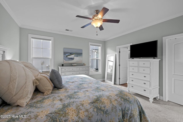 bedroom featuring visible vents, baseboards, light colored carpet, ceiling fan, and ornamental molding