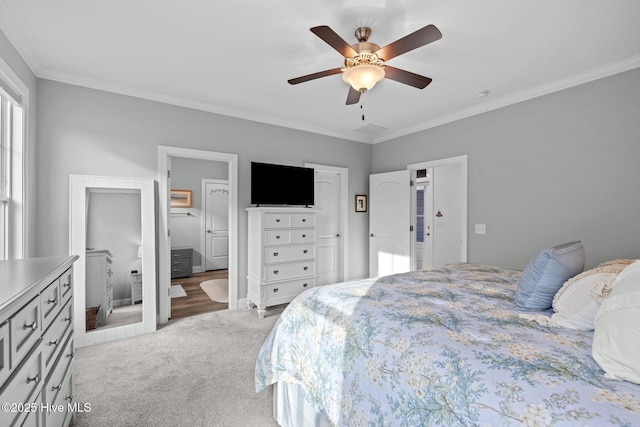 bedroom featuring ornamental molding, light colored carpet, ceiling fan, and ensuite bathroom