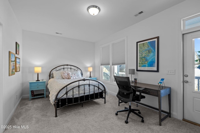 bedroom with visible vents, light carpet, and baseboards