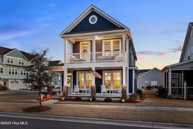 view of front of home with covered porch and a balcony