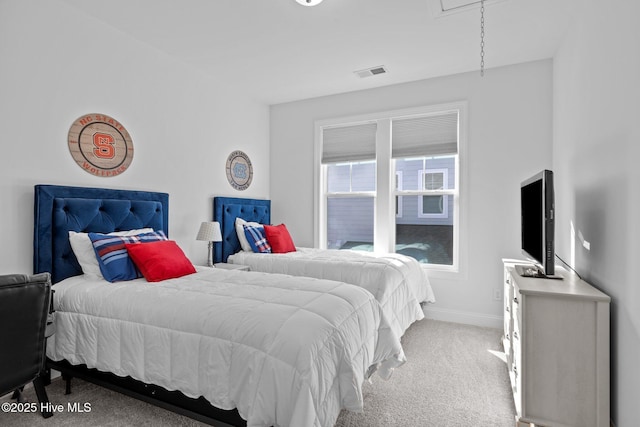 carpeted bedroom featuring visible vents and baseboards