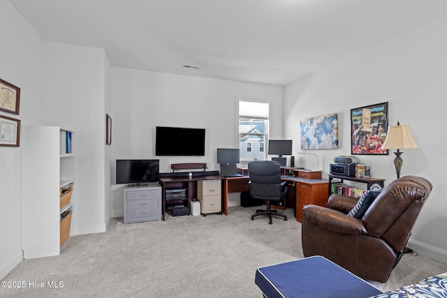 office space with light carpet, visible vents, and baseboards