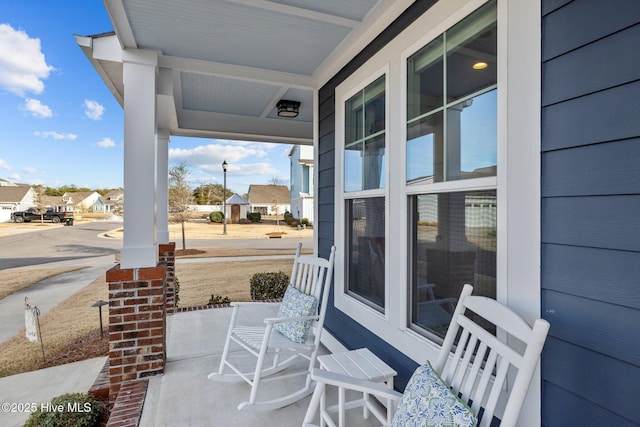 view of patio / terrace with a porch and a residential view