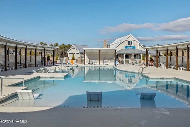 community pool featuring fence and a patio