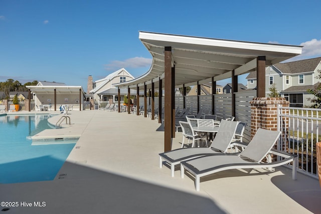 view of patio / terrace with fence and a community pool