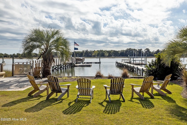 view of yard with a dock and a water view