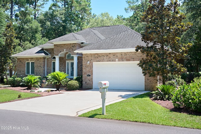 view of front of house with a garage and a front yard