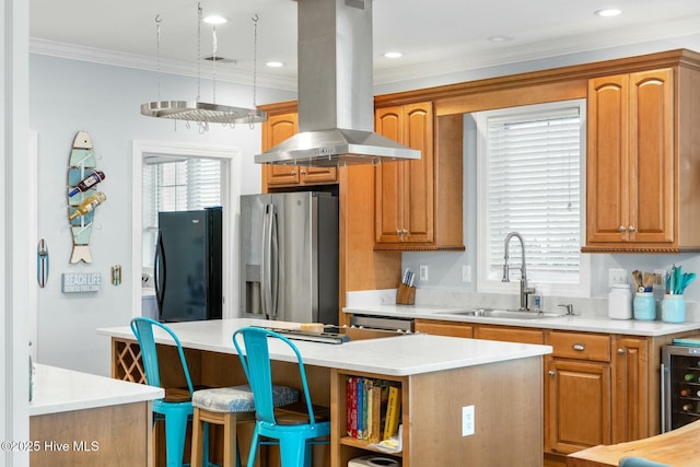 kitchen featuring sink, island range hood, stainless steel fridge with ice dispenser, black refrigerator, and a kitchen island