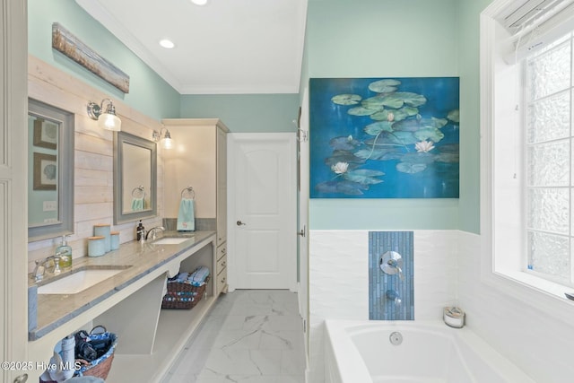 bathroom featuring a bathing tub, ornamental molding, and vanity