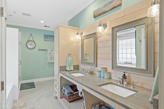 bathroom featuring crown molding and vanity