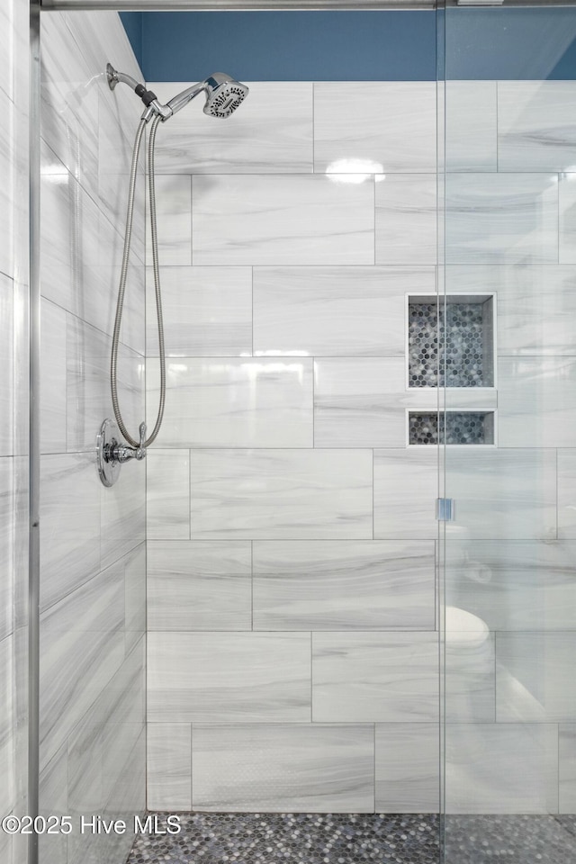 bathroom with tiled shower