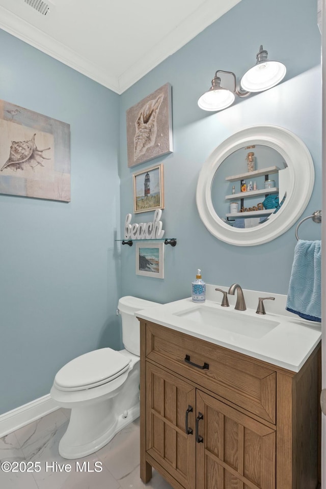 bathroom featuring toilet, marble finish floor, ornamental molding, baseboards, and vanity