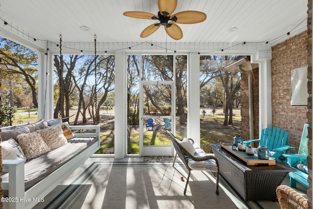 sunroom featuring plenty of natural light and ceiling fan