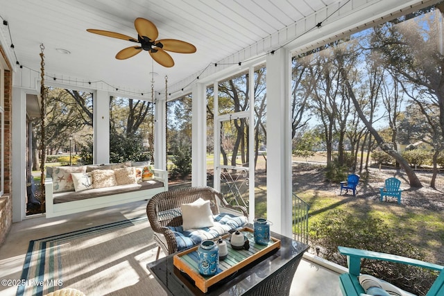 sunroom featuring ceiling fan