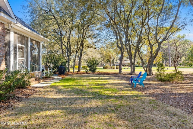 view of yard with a sunroom