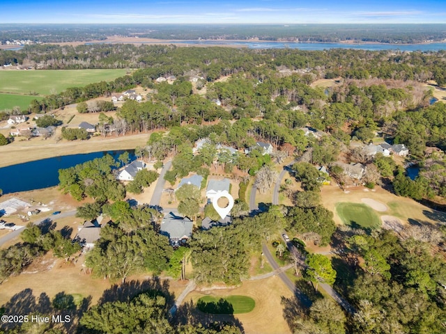 drone / aerial view with golf course view and a water view