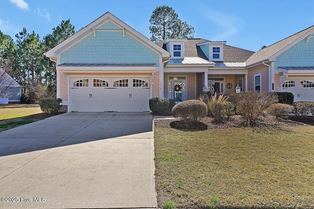 craftsman-style house featuring a garage, a porch, and a front lawn