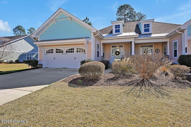 view of front of home featuring a front yard, a garage, and a porch