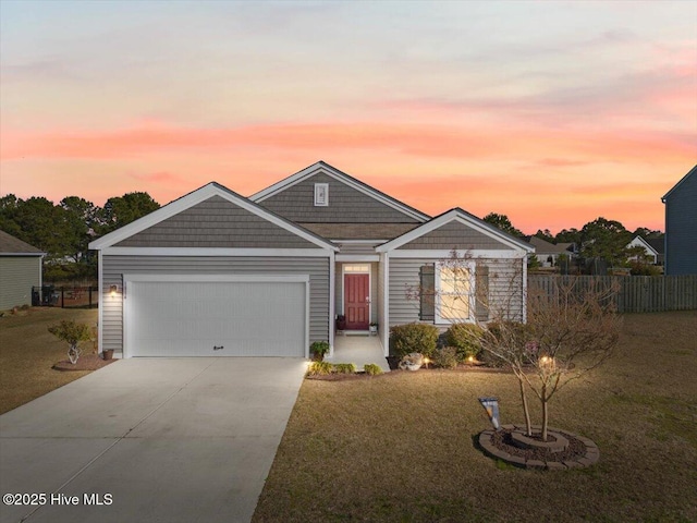 view of front of property featuring a garage and a yard