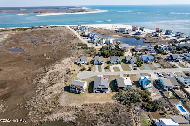 aerial view with a beach view, a water view, and a residential view