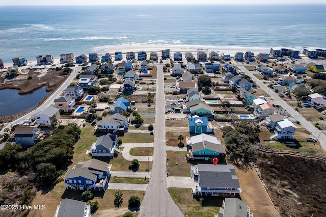 drone / aerial view with a water view and a residential view