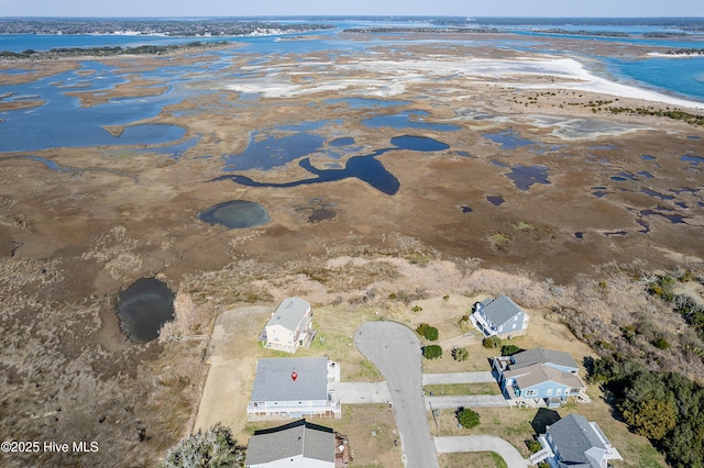 drone / aerial view featuring a water view and a view of the beach