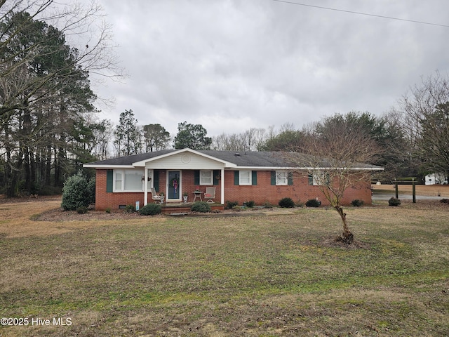 ranch-style house featuring brick siding and a front lawn